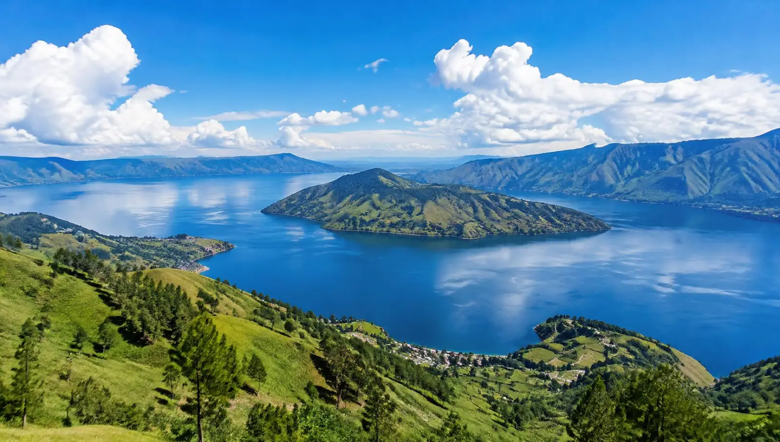 Lake Toba at sunrise with traditional Batak houses, North Sumatra